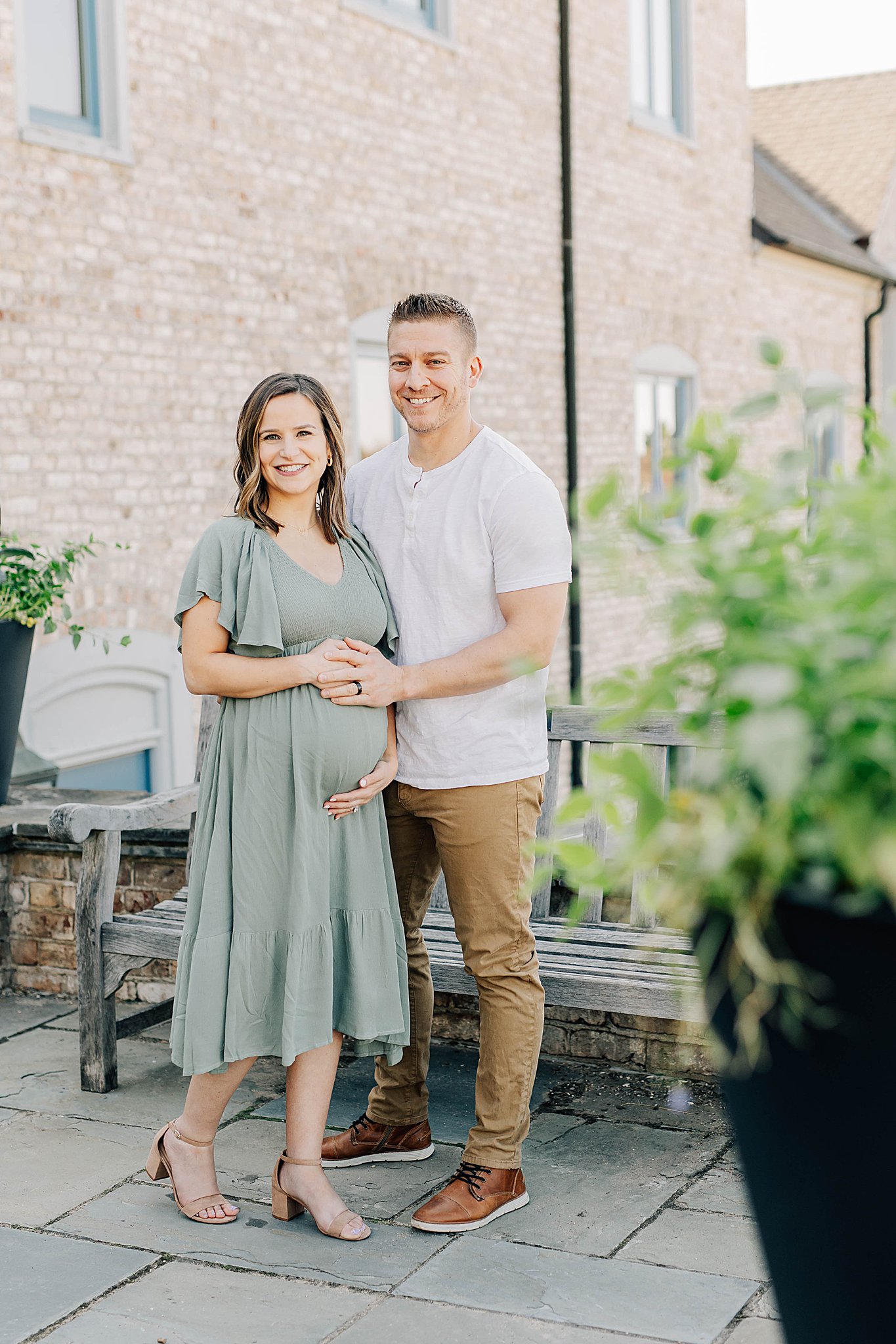 Mom and dad smiling during maternity photos
