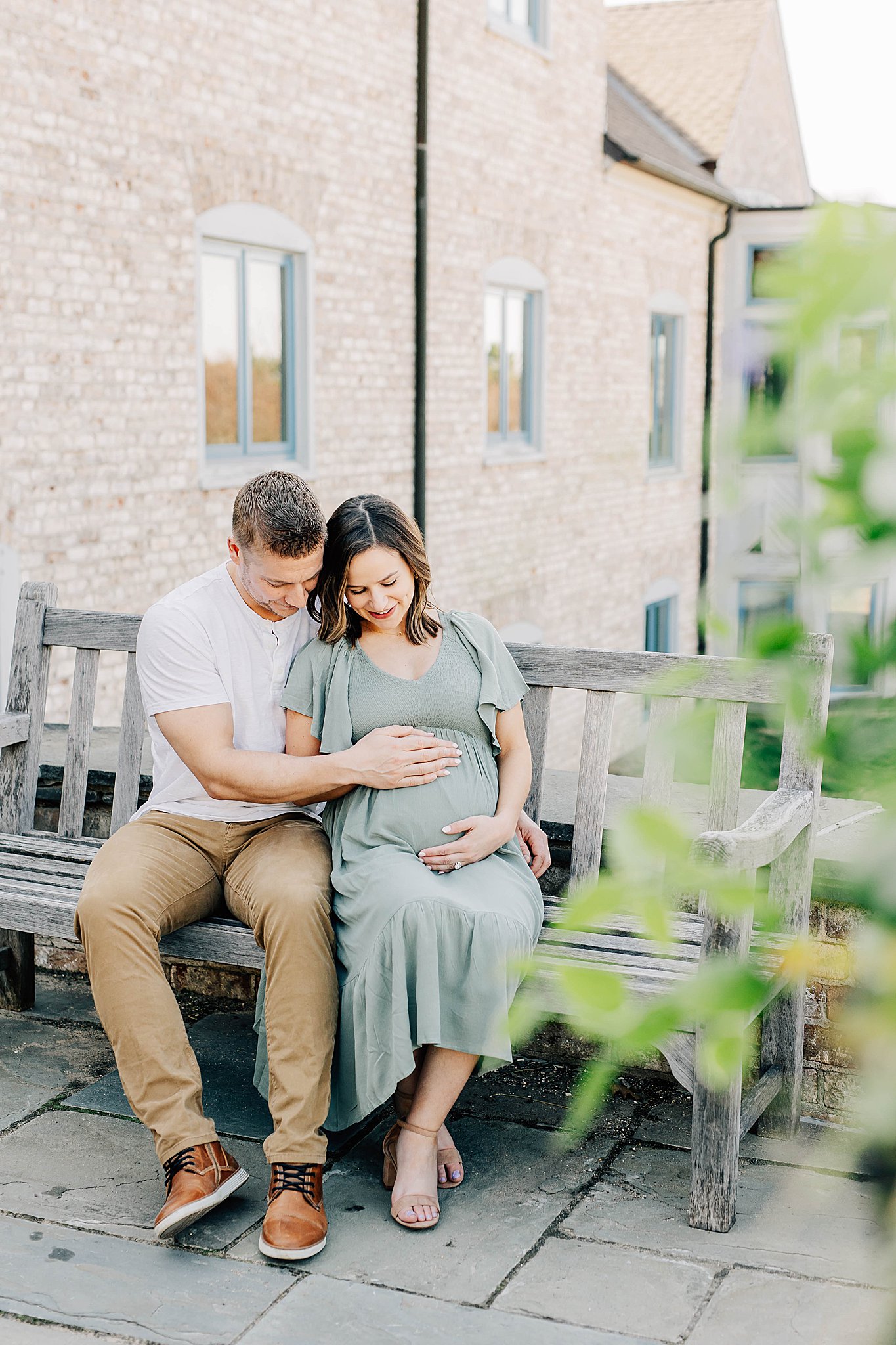Dad touching mom's baby bump during maternity photos