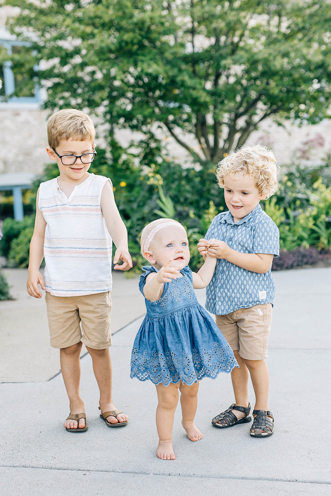 Three kids smiling during summer family photos.