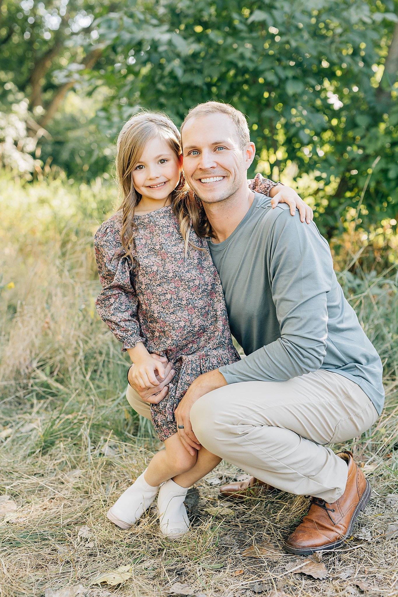 Daughter and dad smiling during family of four fall pictures.