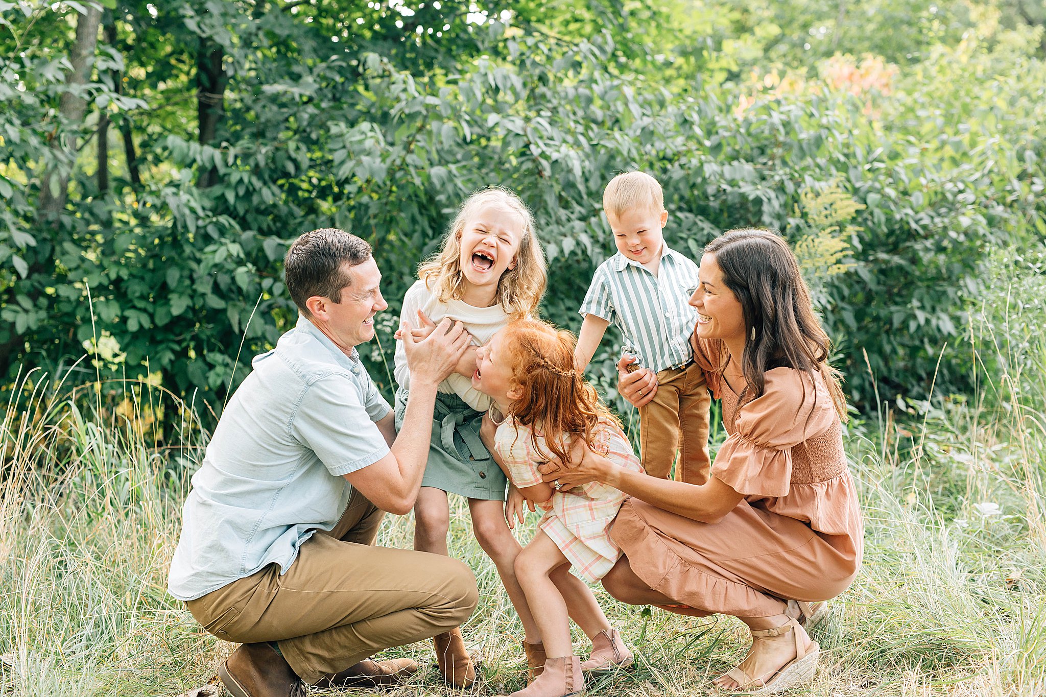 Family of five fall pictures with all five laughing. 
