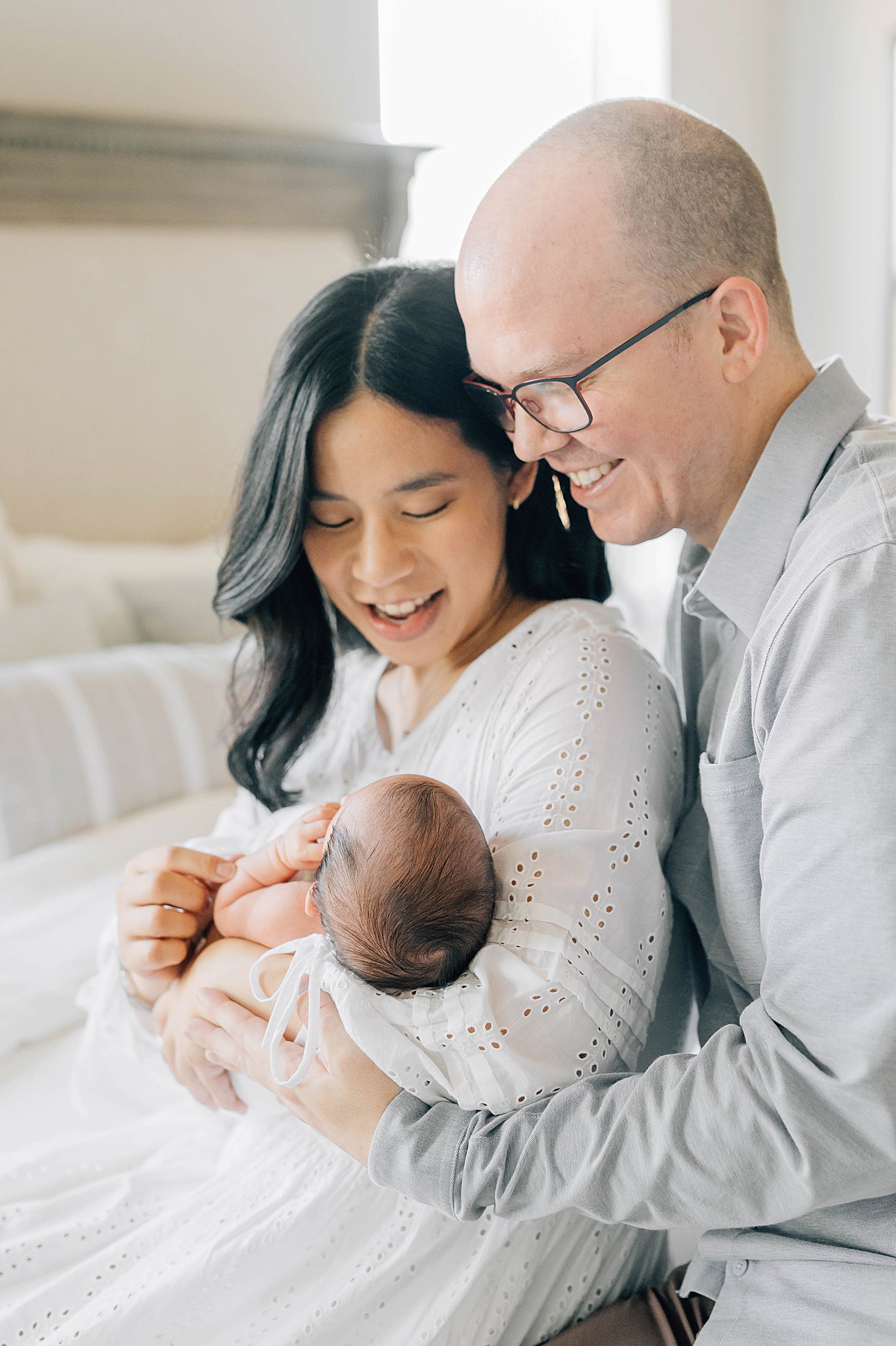 In-home newborn pictures with mom, dad and baby boy. 