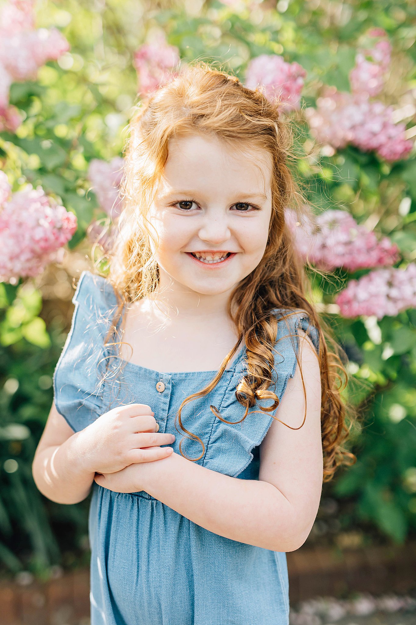 Young girl smiling during what to wear for Spring family pictures.