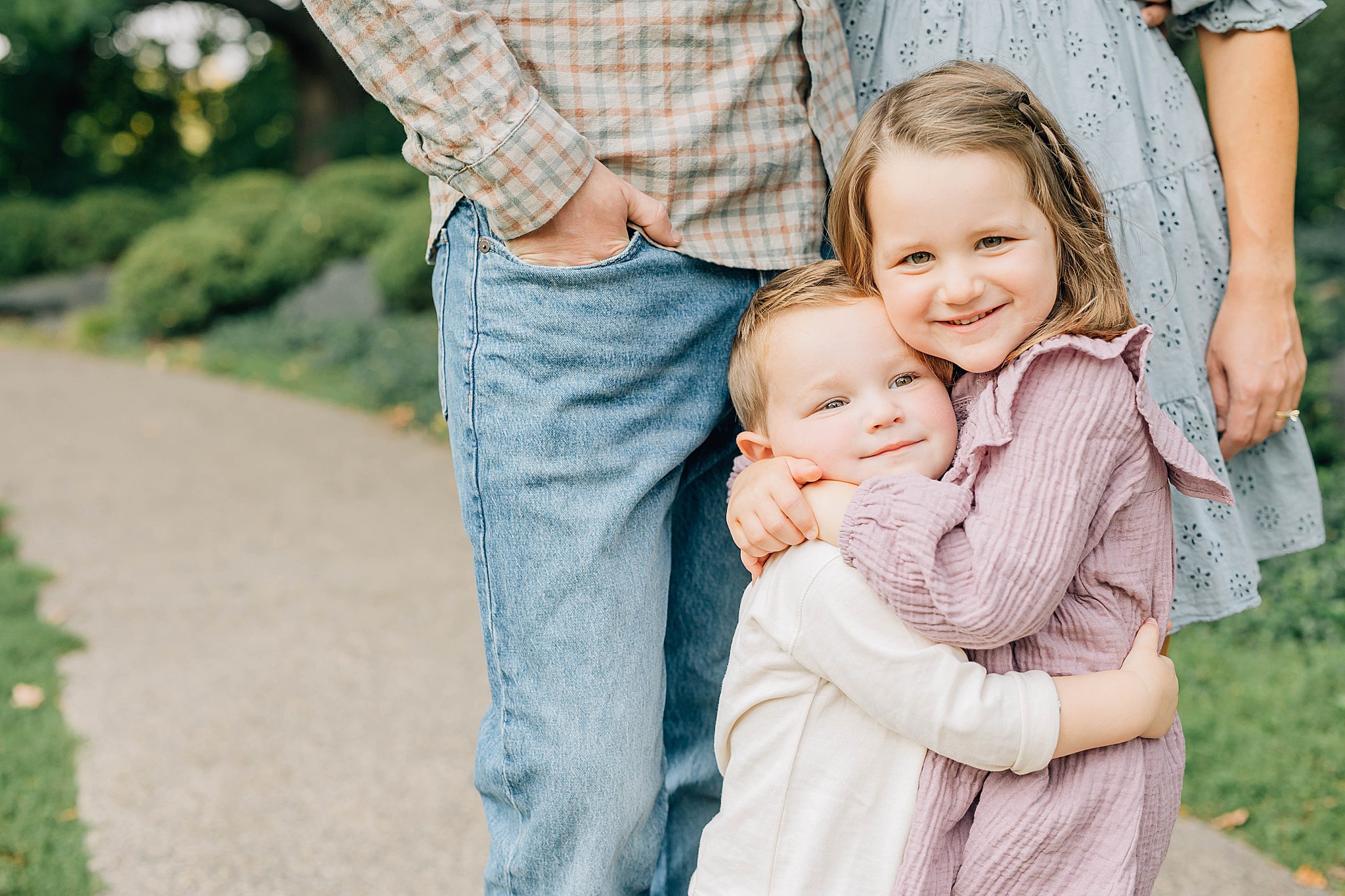 Brother and sister hugging during Minneapolis family photographer session.