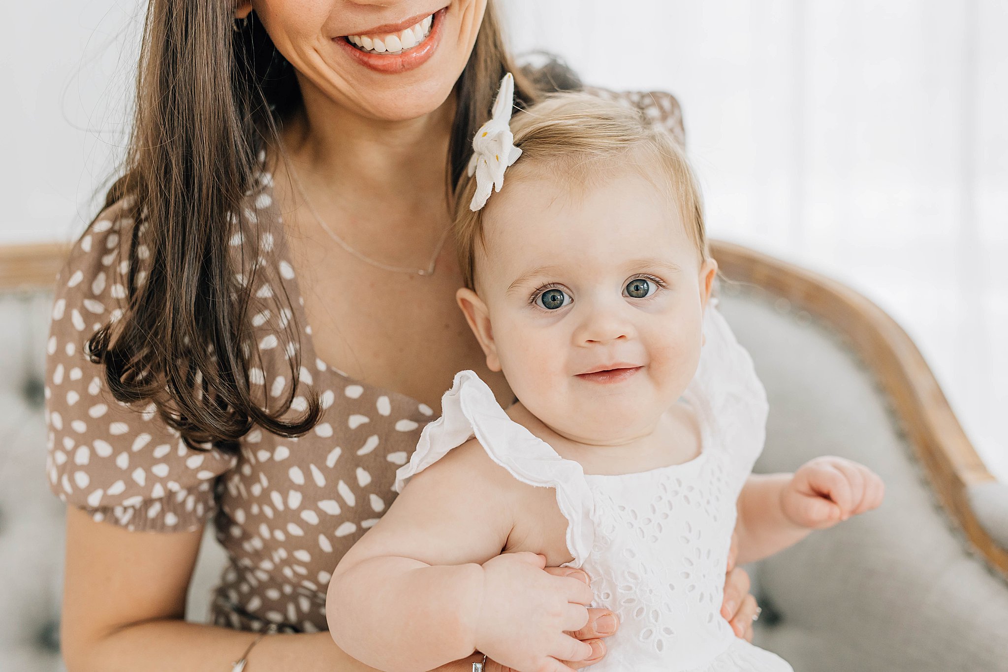 Mom and baby smiling during one year milestone portraits.