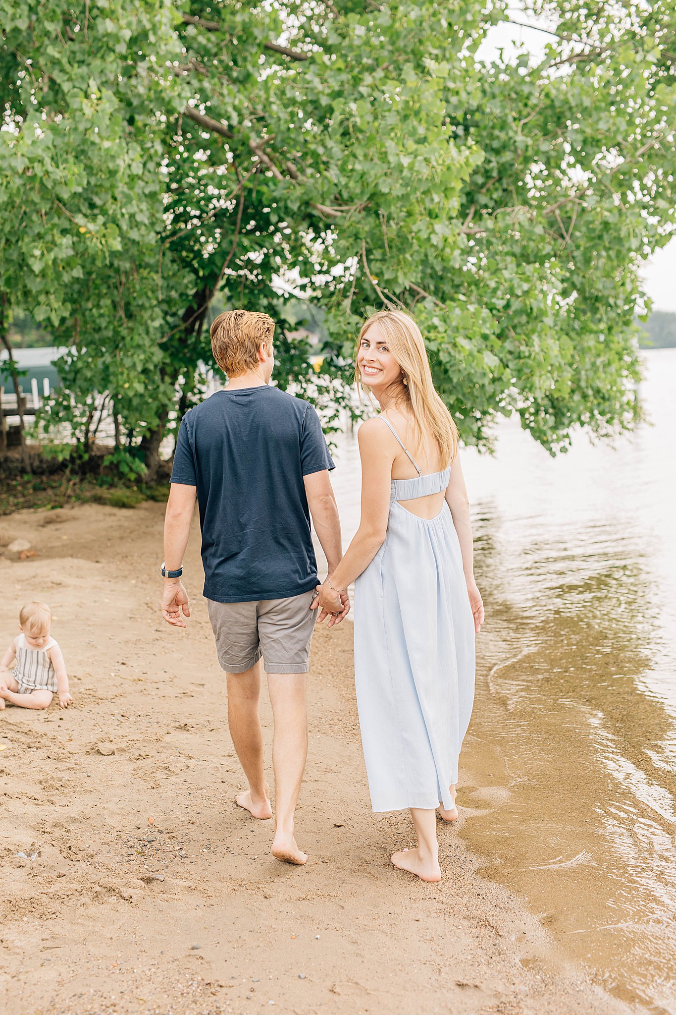 Dad and mom holding hands while walking during Lake Minnetonka Family Pictures.