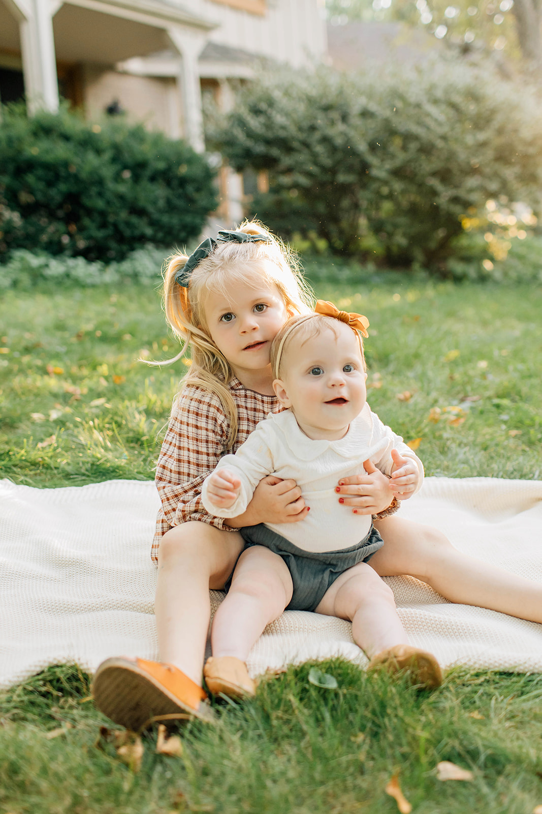 Toddler Sibling and Baby Embrace During Family Photography