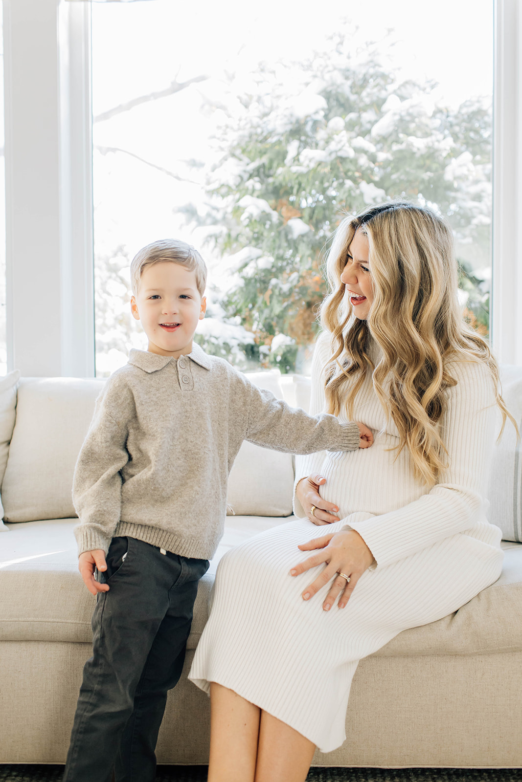 Boy Embraces Moms Baby Bump During Family Photo Session