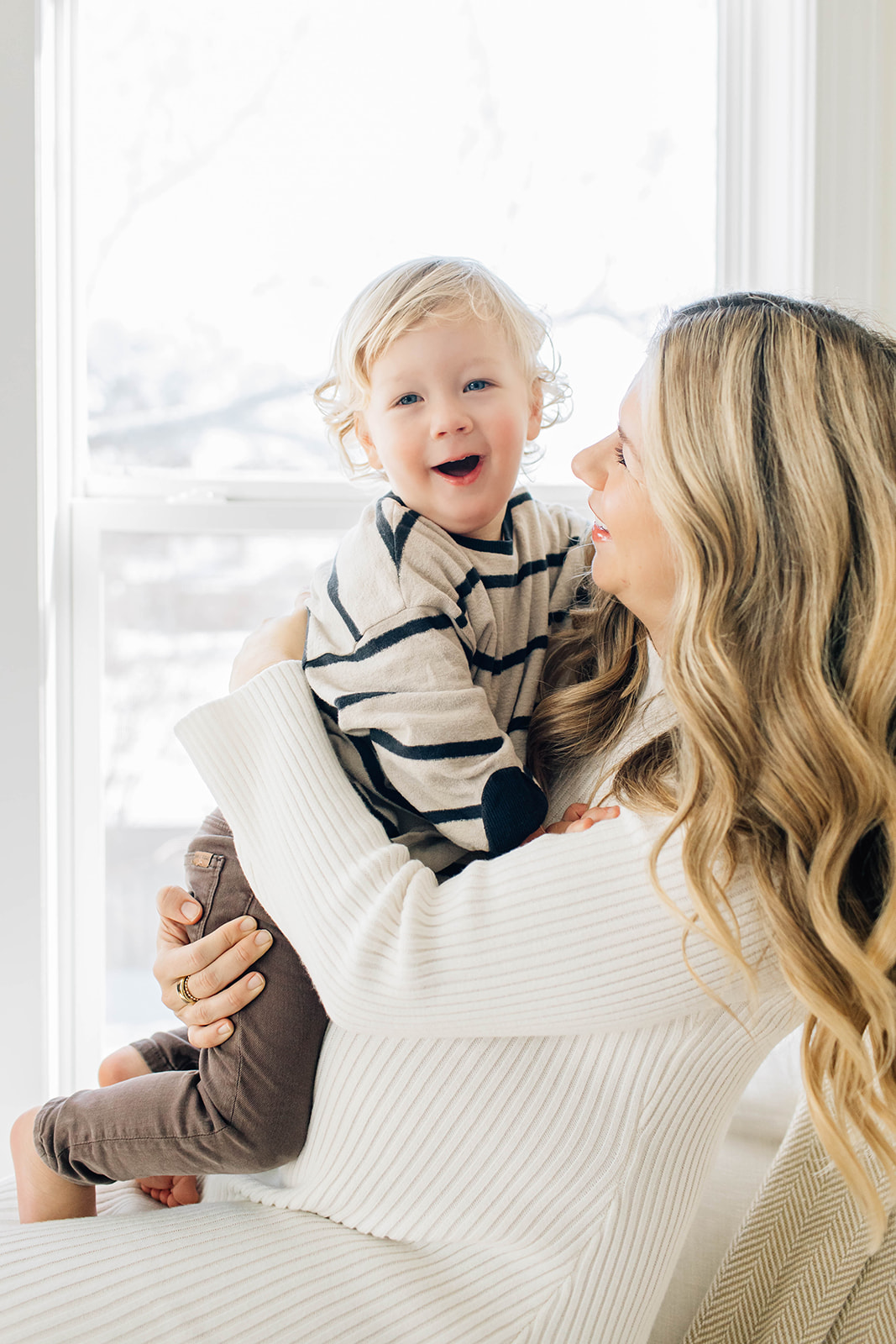 Toddler Boy with Blonde Curls, Laughing and Playing with Mom During Photoshoot