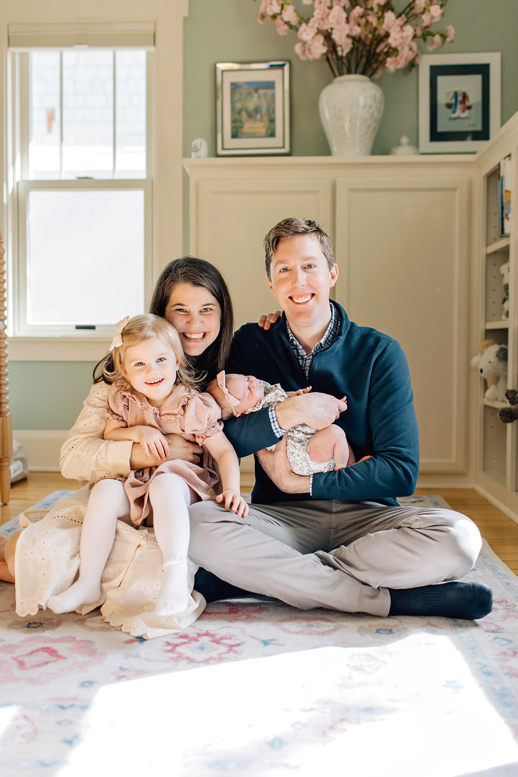 Family of Four, with Newborn and Toddler, Sitting on Floor on Nursery