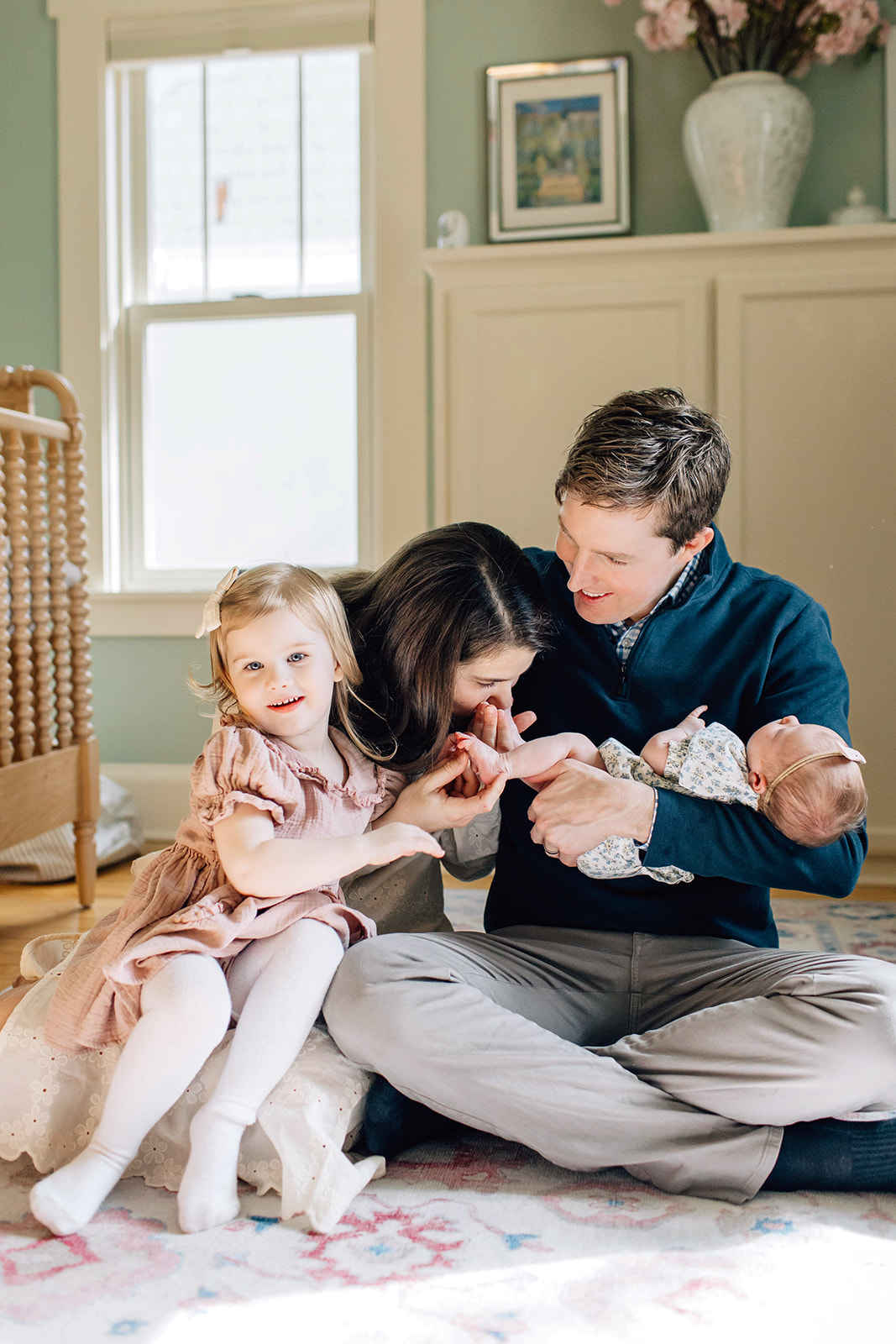 Mom Kisses Baby's Feet During Newborn Family Photoshoot